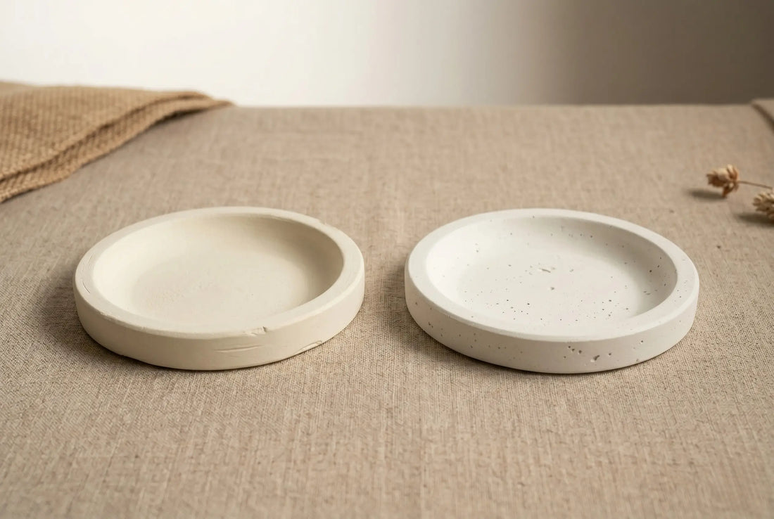 Two cast coasters side-by-side, one made with Artriso CALSO ONE and one with Jesmonite AC100, on a linen surface