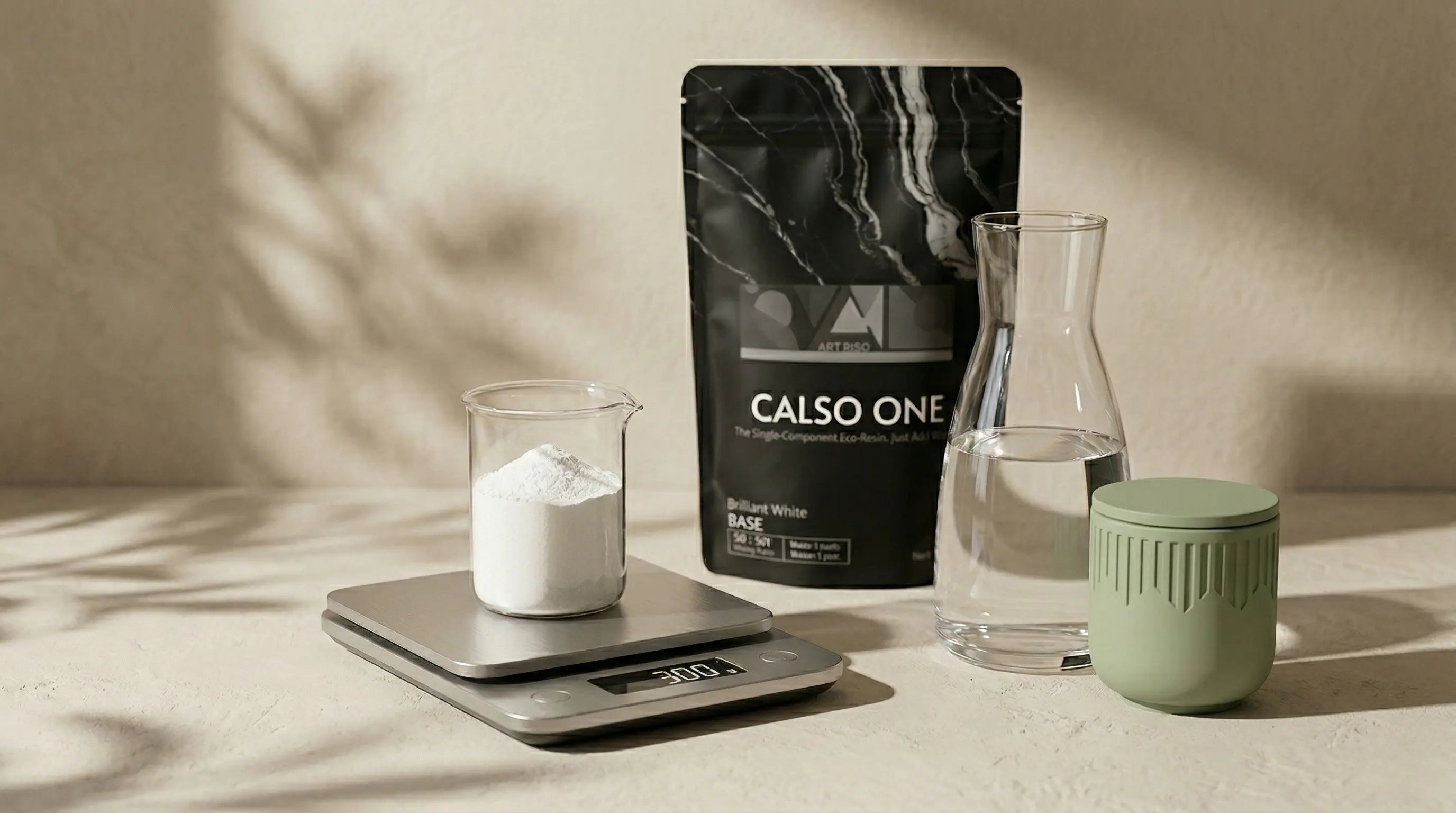 Digital scale and CALSO ONE eco resin powder measured out for a 3:1 mix at an Artriso studio workbench